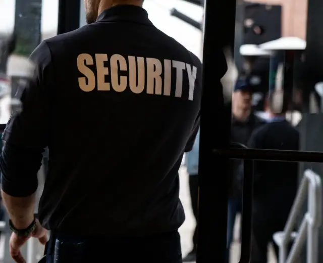 rear-view-of-a-security-guard-in-uniform-patrollin-2025-02-02-14-22-01-utc